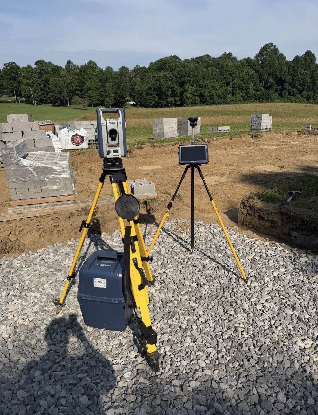 Precision surveying equipment set up on a prepared construction site